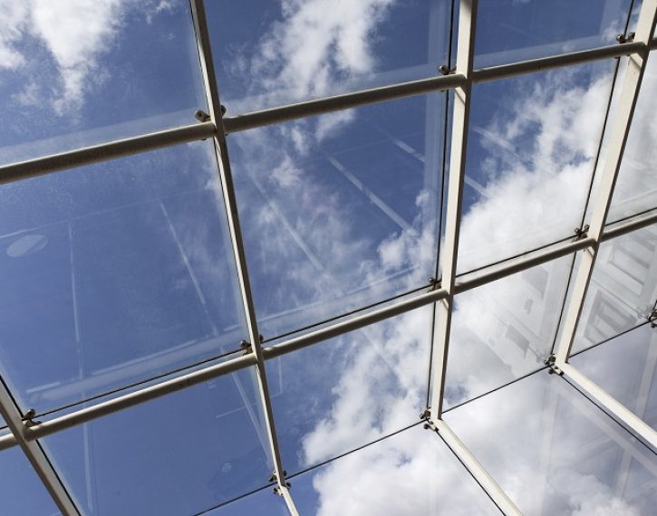 Close up of a glass roof and blue sky